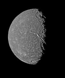 On Jan. 24, 1986, NASA's Voyager 2 returned the highest-resolution picture of Titania, Uranus' largest satellite. Abundant impact craters of many sizes pockmark the ancient surface; most prominent features are fault valleys that stretch across Titania.