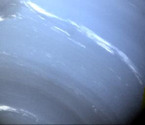 This image of the blue-hued Neptune was taken by NASA's Voyager 2; small trails of similar clouds trending east to west and large scale structure east of the Great Dark Spot all suggest that waves are present in the atmosphere and play a large role.