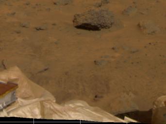 Several objects were imaged by NASA's Mars Pathfinder (IMP) during the spacecraft's first day on Mars, July 4, 1997. Portions of the deflated airbags, part of one the lander's petals, soil, and several rocks are visible.
