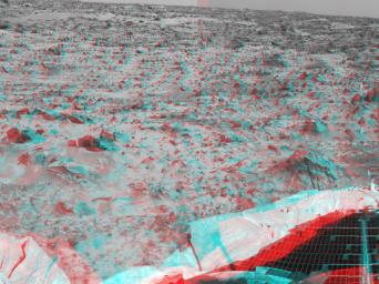 Portions of the lander's deflated airbags and a petal are at lower left in this image from NASA's Mars Pathfinder. 3D glasses are necessary to identify surface detail. 