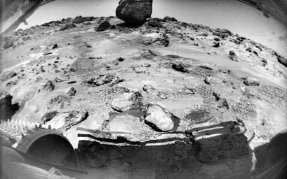 This NASA's Sojourner image, taken on Sol 70, shows rocks and rover-disturbed soil. Cleats on Sojourner's left front wheel are seen at lower left. The large rock in the distance is 'Yogi.'