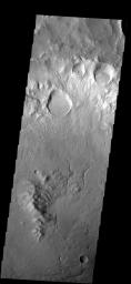 This image from NASA's Mars 2001 Odyssey shows several craters were formed on the rim of this large crater. The movement of material downhill toward the floor of the large crater has formed interesting patterns on the floors of the smaller craters.