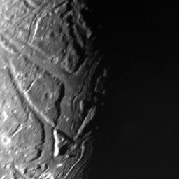 This NASA Voyager 2 view of Uranus' moon Ariel's terminator shows a complex array of transecting valleys with super-imposed impact craters. 