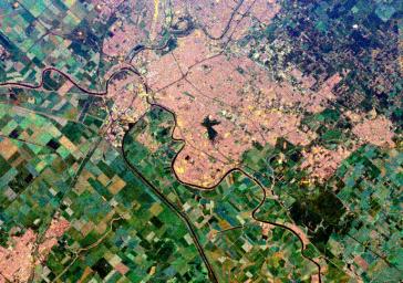 This is a spaceborne radar image from NASA's Spaceborne Imaging Radar C/X-Band Synthetic Aperture Radar of the city of Sacramento, the capital of California. Urban areas appear pink and the surrounding agricultural areas are green and blue.