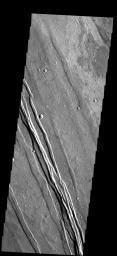 The linear features in this image are called graben and are formed when two parallel faults have a downdropped block of material between them. These graben are located between Syria Planum and Claritas Rupes as seen by NASA's 2001 Mars Odyssey.