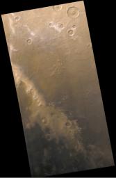 NASA's Mars Global Surveyor shows dark sand exposed from beneath retreating frost on Mars' Mountains of Mitchel.