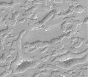 NASA's Mars Global Surveyor shows aprons that surround mesas and buttes of remnant layers on Mars' south polar cap such as two almost triangular features featuring a stair-stepped pattern that suggest these hills are layered.