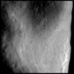This image from NASA's NEAR Shoemaker shows the northeast rim of the saddle region on Eros. Bright sinuous features associated with a ridge are evident as are parallel, closely spaced grooves in the floor of the saddle.