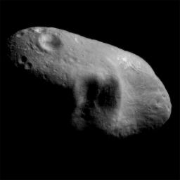 This image from NASA's NEAR Shoemaker shows asteroid Eros' saddle and a shadowed feature to its left, taken on March 3, 2000 from a distance of 127 miles. A shadowed feature that consists of three large craters are situated adjacent to each other.