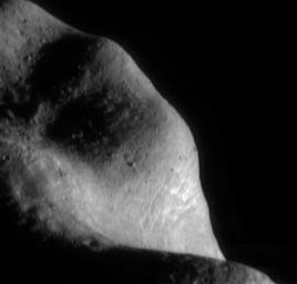 This image of asteroid Eros, taken by NASA's NEAR Shoemaker on March 6, 2000, shows the southwestern part of the saddle region with fragments of Eros' native rock, shattered over the eons by formation of impact craters.