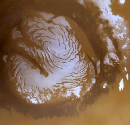 NASA's Mars Global Surveyor shows the martian north polar cap on March 13, 1999, in early northern summer. The light-toned surfaces are residual water ice that remains through the summer season.