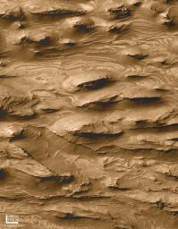 NASA's Mars Global Surveyor shows layered outcrops of far west Candor Chasma on Mars. 
