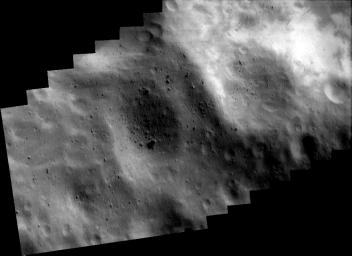 This image of asteroid Eros, taken by NASA's NEAR Shoemaker on May 14, 2000, shows bright patches at upper right that are relatively freshly exposed regolith on the inside wall of the crater.