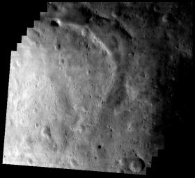 This image of asteroid Eros, taken by NASA's NEAR Shoemaker on May 17, 2000, shows the southern part of Eros' saddle with a wide, curved trough and bright area in the lower left section.