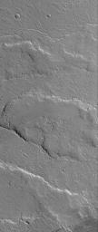 NASA's Mars Global Surveyor shows several overlapping lava flows located on the vast plains east of the volcano, Ascraeus Mons on Mars. Hundreds of lava flows cover the plains from Ascraeus Mons eastward to Kasei Valles. 