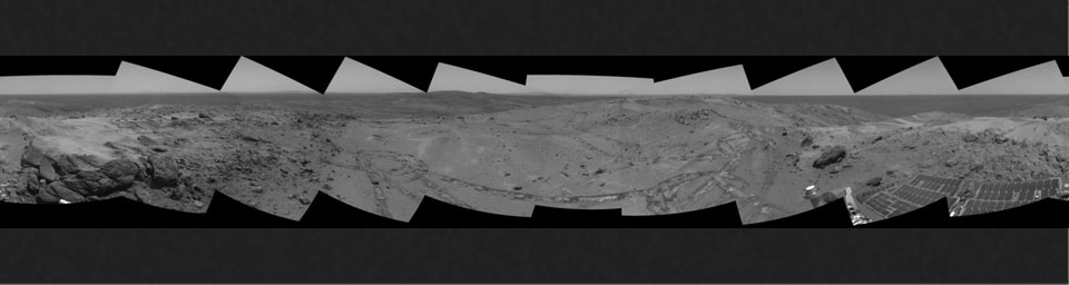 This view from NASA's Mars Exploration Rover Spirit taken on Oct 7, 2005 looked back at the long and winding trail of twin wheel tracks the rover created to get to the top of 'Husband Hill' perched on a lofty, rock-strewn incline. 