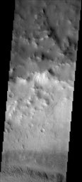 NASA's 2001 Mars Odyssey spacecraft shows that the dust avalanches found on this crater rim have exposed darker rocky material on an otherwise dust coated slope. This unnamed crater is located east of Schiaparelli Crater on Mars.