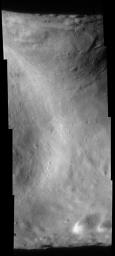 This image of asteroid Eros, taken by NASA's NEAR Shoemaker on Sept. 9, 2000, shows Eros' saddle, and curving around at upper right is the large bright-and-dark groove.