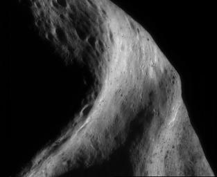 This image of asteroid Eros, taken by NASA's NEAR Shoemaker on Sept.26, 2000, shows a broad, curved depression that stretches vertically across the image is an area of the asteroid.