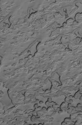 NASA's Mars Global Surveyor shows eroding mesas of frozen carbon dioxide in the martian south polar residual cap. During the summer season, the scarps that bound each pit and mesa in the south polar region become dark as carbon dioxide sublimes away.