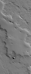 NASA's Mars Global Surveyor shows an ancient lava flow surface near the volcano, Ascraeus Mons on Mars. The volcanic material has been completely covered by thick accumulations of dust.