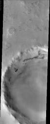 This image from NASA's Mars Odyssey spacecraft displays a frosted crater in the Martian northern hemisphere. It was taken during the northern spring, when the CO2 ice cap starts to sublimate and recede.