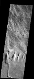 This image from NASA's Mars Odyssey spacecraft is located on the SE flank of Arsia Mons where it meets the plains. Collapse features are present at the margin of the volcano.