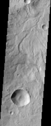 This image by NASA's Mars Odyssey spacecraft shows the rugged cratered highland region of Libya Montes, which forms part of the rim of an ancient impact basin called Isidis.