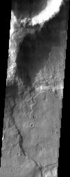 This pair of craters seen by NASA's Mars Odyssey just north of the Hellas Basin demonstrate the rugged topography that can result when an impact occurs on the rim of an existing crater.
