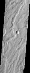This scene from NASA's Mars Odyssey spacecraft of the dust covered plains of eastern Arabia Terra portrays a range of geological time. Three craters at the center of the image capture some of this range.