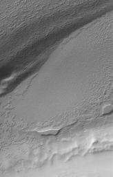 NASA's Mars Global Surveyor shows eroded remnants of carbon dioxide ice in the south polar residual cap of Mars.