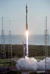 With the Atlantic Ocean as a backdrop, an Atlas V launch vehicle, 19 stories tall, with a two-ton NASA Mars Reconnaissance Orbiter (MRO) on top, roars away from Launch Complex 41 at Cape Canaveral Air Force Station.