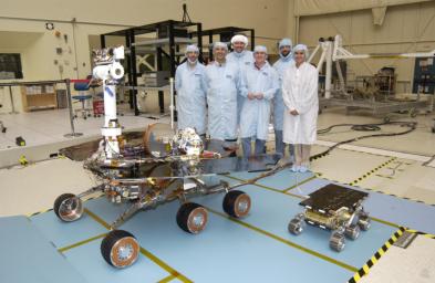 Members of the Mars Exploration Rovers Assembly, Test and Launch Operations team gather around NASA's Rover 2 and its predecessor, a flight spare of the Pathfinder mission's Sojourner rover, named 'Marie Curie.'