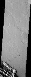 This image from NASA's Mars Odyssey spacecraft shows several lava flows in Lycus Sulci. Notice the streamlined features near the bottom of the image indicating the flow direction.