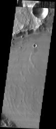 This image taken by NASA's 2001 Mars Odyssey shows the Medusae Fossae Formation, in a region dissected by channels, lies an unnamed crater that may have been filled by mud on the martian landscape.
