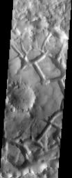 This image taken by NASA's 2001 Mars Odyssey shows chaotic terrain on Mars is thought to form when there is a sudden removal of subsurface water or ice, causing the surface material to slump and break into blocks.