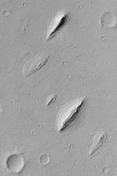 NASA's Mars Global Surveyor shows wind-sculpted remnants of layered sedimentary rock that once completely covered the northwestern floor of Henry Crater, an ancient impact basin on Mars.
