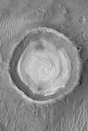 NASA's Mars Global Surveyor shows dozens of layers of similar thickness and physical properties in a wedding cake-like stack in the middle of an old meteor impact crater in northwestern Schiaparelli Basin on Mars.