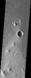 NASA's Mars Odyssey spacecraft captured this image in July 2003 of platy flows covering the plains of Southern Elysium on Mars. These flows appear to be very fluid lava flows but a mudflow origin can't be completely ruled out for these flows.