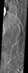 NASA's Mars Odyssey spacecraft captured this image in July 2003, showing a complex process of deposition, burial and exhumation. The crater ejecta at top is in the form of flow lobes, indicating that the crater was formed in volatile-rich terrain.