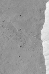 NASA's Mars Global Surveyor shows the western summit region of Olympus Mons on Mars featuring a lava flow that was cut by the pit walls when the caldera collapse occurred.