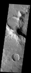 Two craters east of the Hellas impact basin dominate the field of view. The craters are alike in that they have been filled in by a lot of material after they were formed. This image was captured by NASA's Mars Odyssey spacecraft in October 2003.