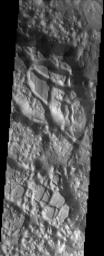 Aureum Chaos is a large crater that was filled with sediment after its formation. This image was captured by NASA's Mars Odyssey spacecraft in November 2003.