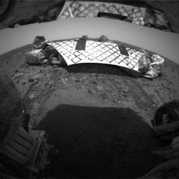 This image from NASA's Mars Exploration Rover Spirit's rear hazard identification camera shows the rover's hind view of the lander platform. Tracks were left in the martian soil by the rovers' wheels, all six of which had rolled off the lander. 