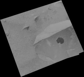 NASA's Mars Exploration Rover Spirit shows a cleaned off portion of the rock dubbed Adirondack. In preparation for grinding into the rock, Spirit wiped off a fine coat of dust with a brush located on its rock abrasion tool.