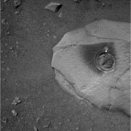 The round, shallow depression in this image resulted from history's first grinding of a rock on Mars. The rock abrasion tool on NASA's Spirit rover ground off the surface of a patch 1.8 inches in diameter on a rock called Adirondack.