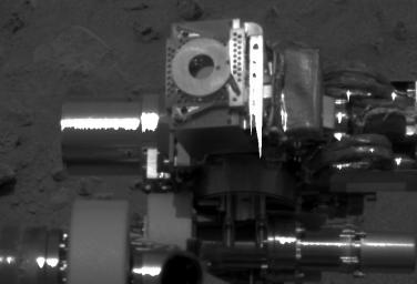 This close-up image of NASA's Mars Exploration Rover Spirit's instrument deployment device, or 'arm,' shows the donut-shaped plate on the Moessbauer spectrometer. 