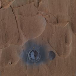 This image was taken by NASA's Mars Exploration Rover Spirit during the rover's grinding of the rock dubbed 'Mazatzal.' Dark grey coating is seen after brushing remains on the right side of the hole, while the left side is the underlying basaltic rock.