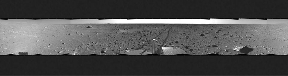 This cylindrical-projection view was created from navigation camera images that NASA's Mars Exploration Rover Spirit acquired on May 12, 2004. The tracks show the path the rover had traveled so far on its way to the base of the 'Columbia Hills.'