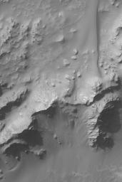 NASA's Mars Global Surveyor shows some of the mountains that make up the central peak region of Hale Crater on Mars. The central peak of a crater consists of rock brought up during the impact from below the crater floor.